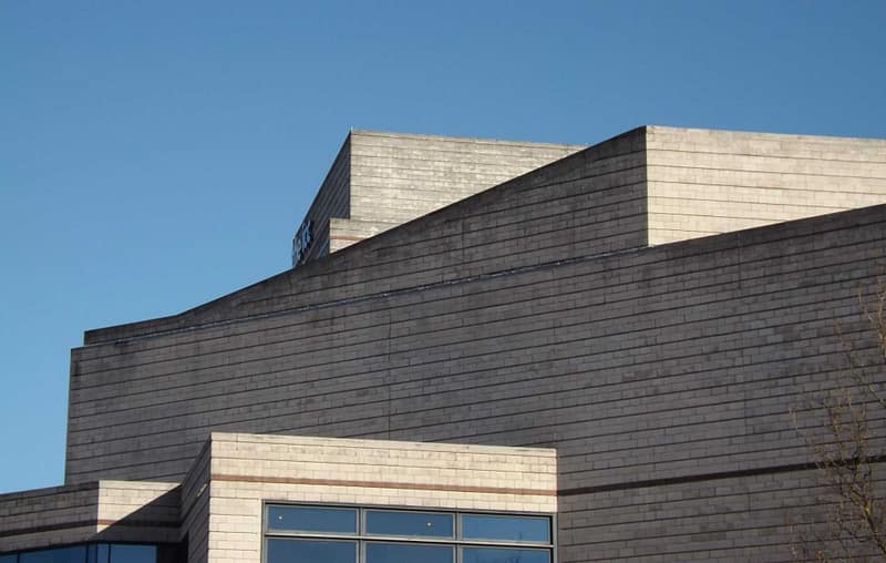 gray concrete building under a calm blue sky